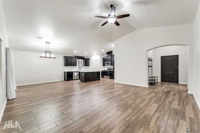 12616 E 49th Dr, Yuma, AZ 85367 - unfurnished living room with ceiling fan, a sink, light wood-style floors, arched walkways, and visible vents