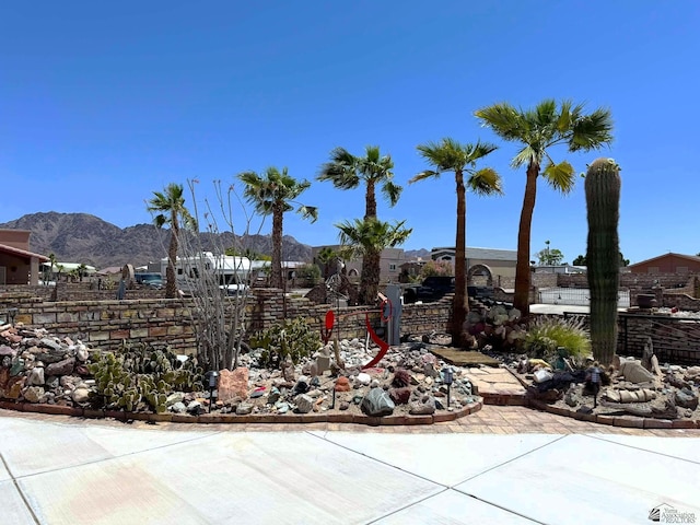 exterior space with a mountain view and fence