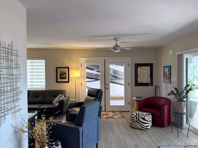 living room featuring ceiling fan, french doors, wood finished floors, and visible vents