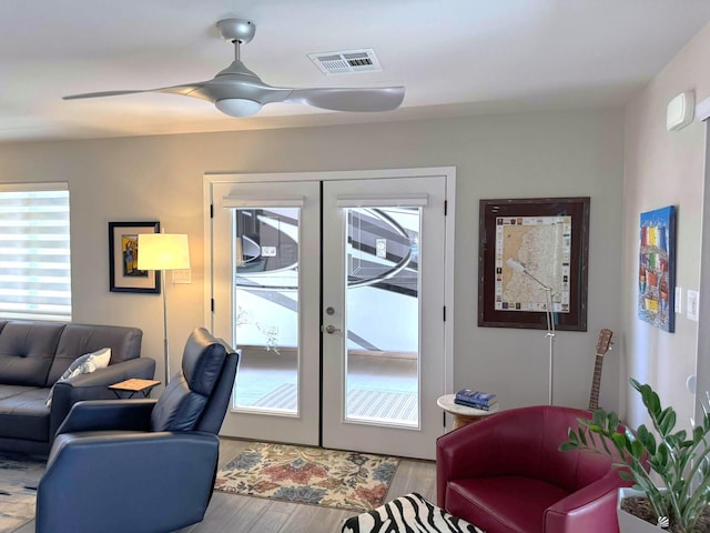 doorway with french doors, wood finished floors, and visible vents