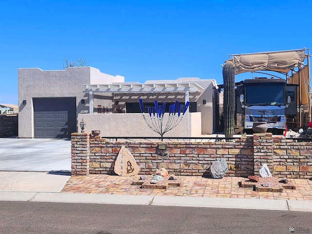 view of front facade featuring concrete driveway, a garage, and stucco siding