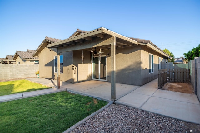 4780 W 11th Ln, Yuma, AZ 85364 - back of house with stucco siding, a tiled roof, and a ceiling fan