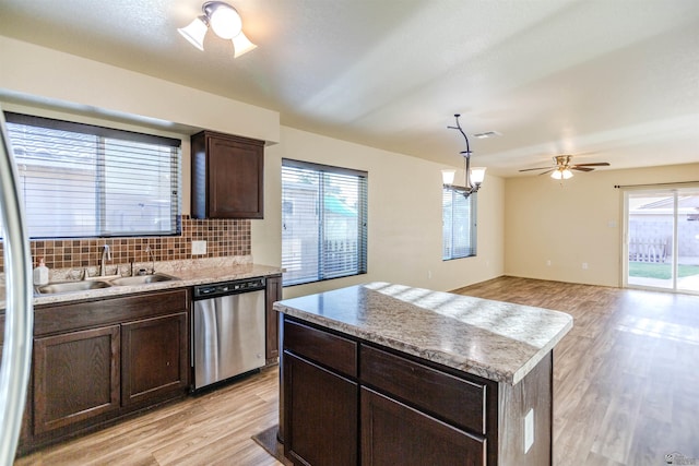 4780 W 11th Ln, Yuma, AZ 85364 - kitchen featuring stainless steel dishwasher, light wood-type flooring, a sink, backsplash, and dark brown cabinetry