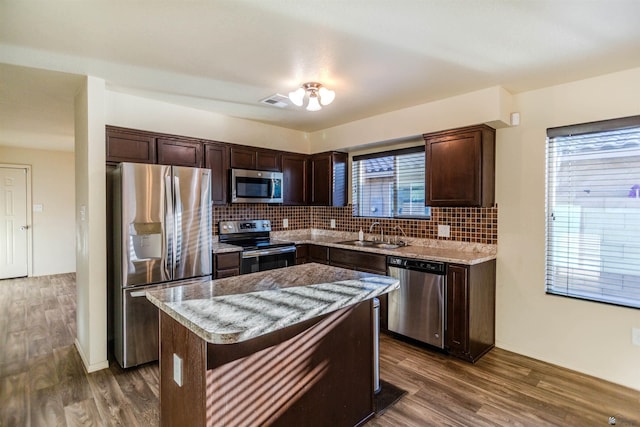 4780 W 11th Ln, Yuma, AZ 85364 - kitchen featuring appliances with stainless steel finishes, dark brown cabinetry, dark wood-style floors, backsplash, and light stone countertops
