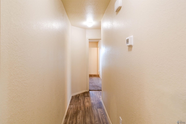 4780 W 11th Ln, Yuma, AZ 85364 - hallway featuring dark wood finished floors, baseboards, and a textured wall