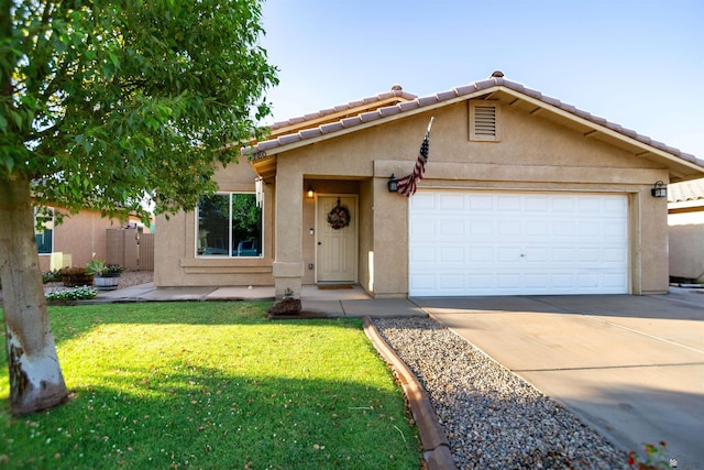 4780 W 11th Ln, Yuma, AZ 85364 - view of front facade with stucco siding, driveway, a front lawn, and an attached garage