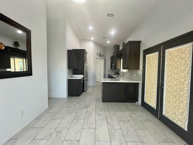 8756 E 41st St, Yuma, AZ 85365 - kitchen with light countertops, a sink, lofted ceiling, decorative backsplash, and stainless steel appliances