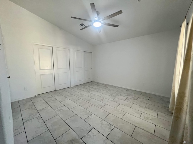 8756 E 41st St, Yuma, AZ 85365 - unfurnished bedroom featuring lofted ceiling, two closets, and ceiling fan