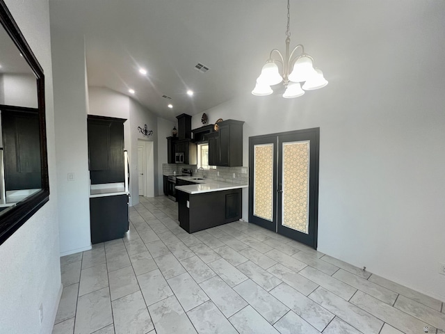 8756 E 41st St, Yuma, AZ 85365 - kitchen featuring stainless steel appliances, light countertops, dark cabinets, a chandelier, and tasteful backsplash