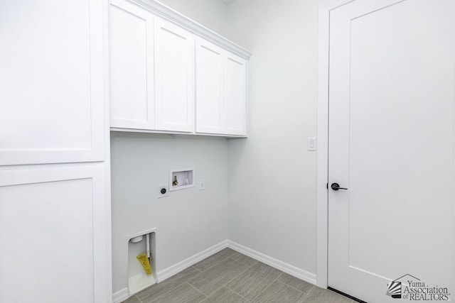 laundry room with washer hookup, baseboards, electric dryer hookup, and cabinet space