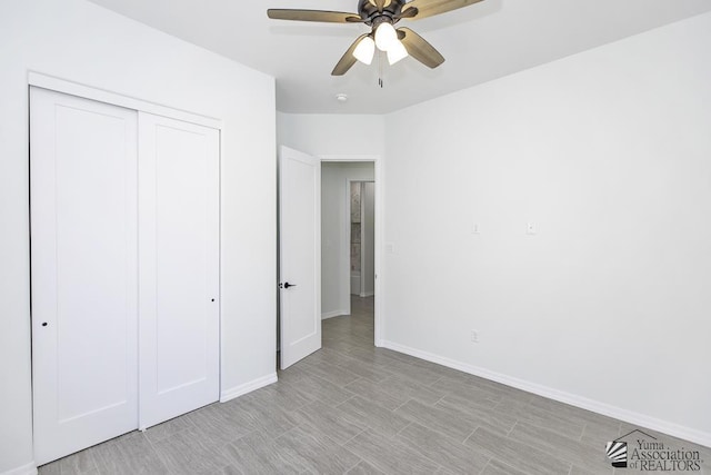 unfurnished bedroom with a ceiling fan, baseboards, and a closet