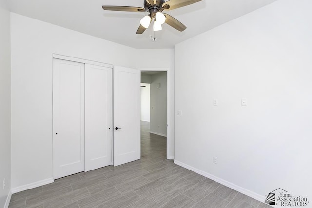 unfurnished bedroom featuring baseboards, ceiling fan, light wood-style flooring, and a closet