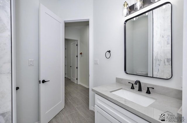 bathroom with baseboards and vanity