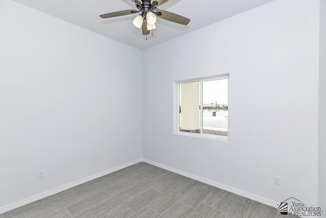 empty room with baseboards and a ceiling fan