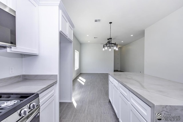 kitchen with visible vents, recessed lighting, white cabinets, a notable chandelier, and stainless steel appliances