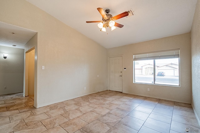 empty room featuring lofted ceiling and ceiling fan