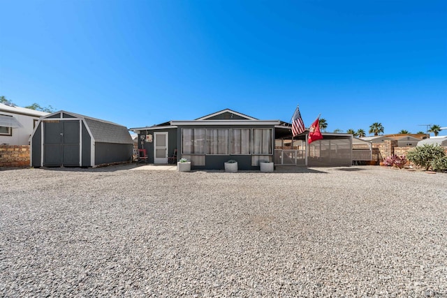 14419 E Fortuna Palms Pl, Yuma, AZ 85367 - rear view of property featuring fence, a storage unit, an outdoor structure, and a sunroom