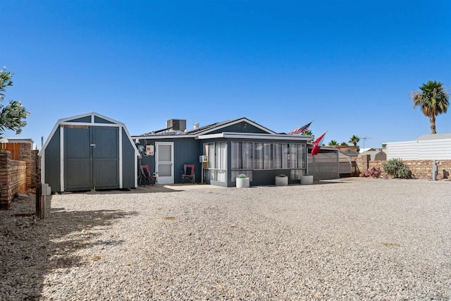 14419 E Fortuna Palms Pl, Yuma, AZ 85367 - back of house with fence, an outbuilding, a shed, and a sunroom
