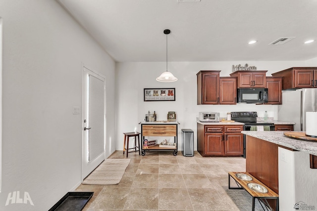 kitchen featuring decorative light fixtures and black appliances