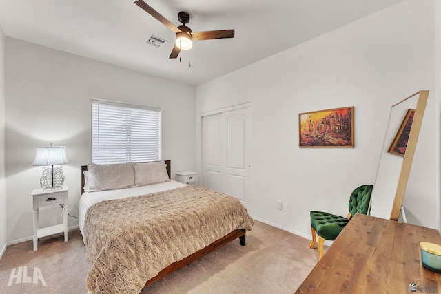 carpeted bedroom featuring ceiling fan and a closet