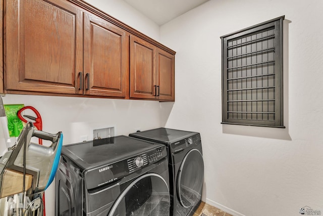 laundry room with cabinets and washer and dryer