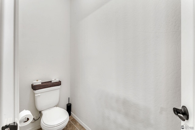 bathroom with tile patterned floors and toilet