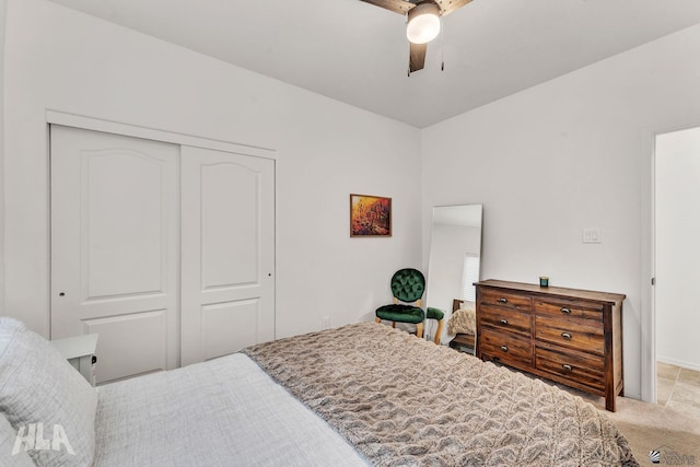 carpeted bedroom featuring ceiling fan and a closet