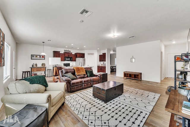 living room with light hardwood / wood-style floors