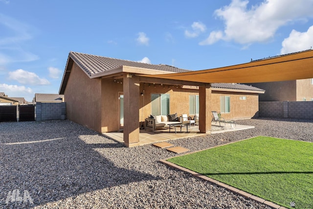 rear view of property featuring an outdoor hangout area and a patio area