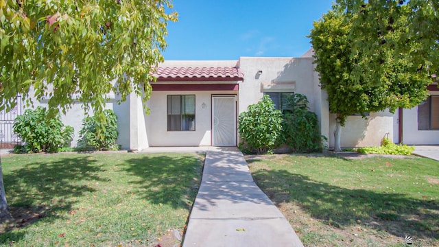 1700 S Crowder Ave Unit # 27, Yuma, AZ 85364 - view of front facade featuring stucco siding, a front lawn, and a tile roof