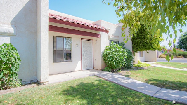 1700 S Crowder Ave Unit # 27, Yuma, AZ 85364 - exterior space with a lawn, stucco siding, and a tile roof
