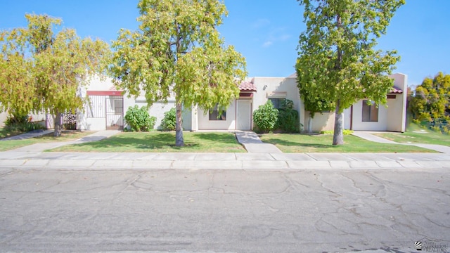 1700 S Crowder Ave Unit # 27, Yuma, AZ 85364 - view of front of property with stucco siding, a tile roof, and a front yard