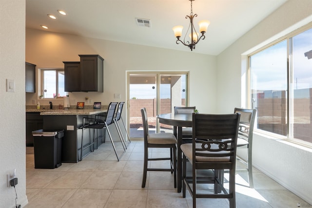 11602 E 33rd St, Yuma, AZ 85367 - dining space with visible vents, light tile patterned floors, lofted ceiling, and an inviting chandelier