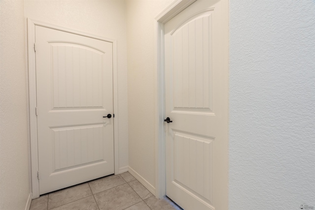 11602 E 33rd St, Yuma, AZ 85367 - doorway to outside with light tile patterned floors, baseboards, and a textured wall