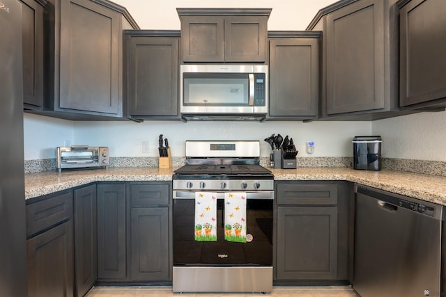 11602 E 33rd St, Yuma, AZ 85367 - kitchen featuring a toaster, light stone counters, and stainless steel appliances