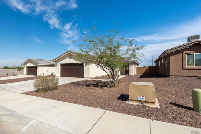11602 E 33rd St, Yuma, AZ 85367 - view of front of home with fence, an attached garage, driveway, and stucco siding