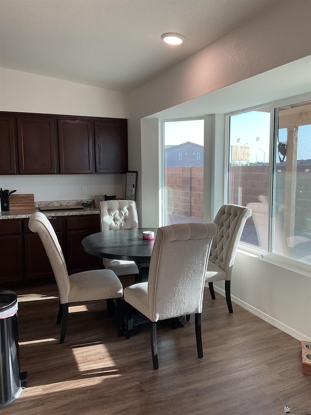 dining room with baseboards and wood finished floors