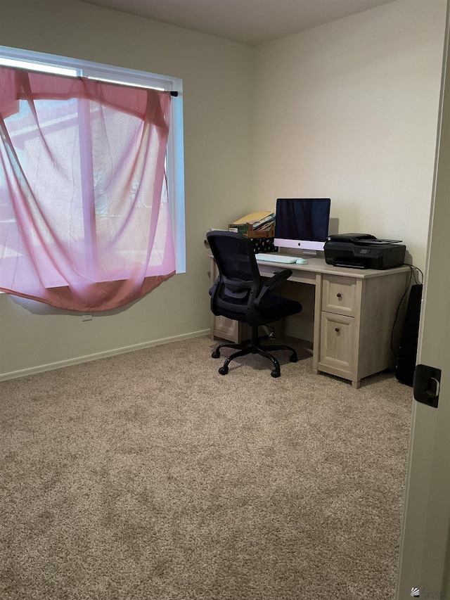 home office with baseboards and light colored carpet