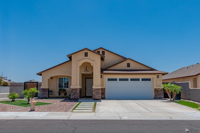 3775 E Udall Ln, San Luis, AZ 85349 - view of front of house with stone siding, stucco siding, a garage, concrete driveway, and fence