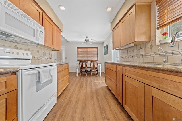 1215 S 41st Dr, Yuma, AZ 85364 - kitchen with white appliances, a sink, light wood-style flooring, decorative backsplash, and ceiling fan