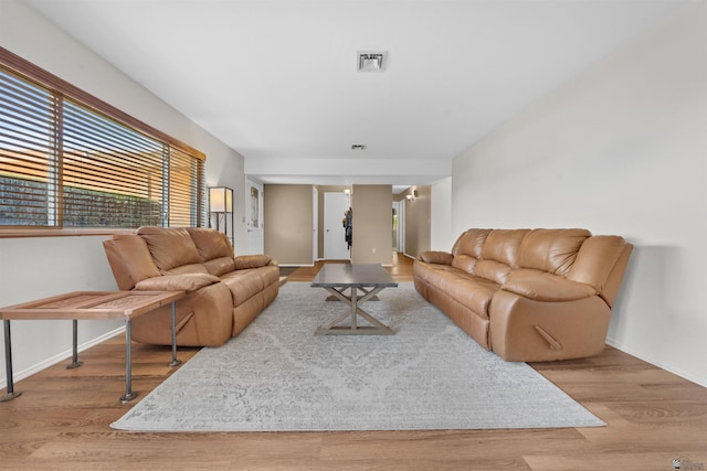 1215 S 41st Dr, Yuma, AZ 85364 - living room featuring wood finished floors, baseboards, and healthy amount of natural light
