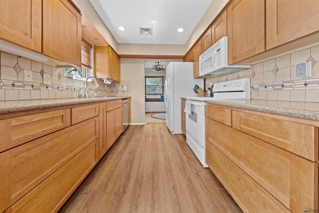 1215 S 41st Dr, Yuma, AZ 85364 - kitchen featuring white appliances, light wood-type flooring, a sink, tasteful backsplash, and recessed lighting