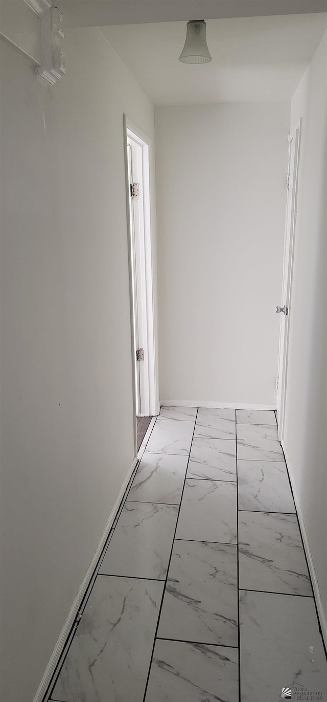 hall featuring marble finish floor
