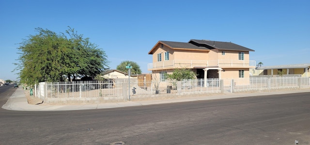 view of front of property with a fenced front yard and stucco siding