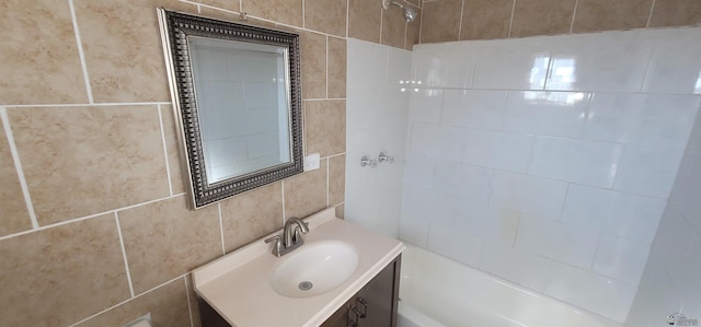 bathroom with vanity, bathing tub / shower combination, and tile walls