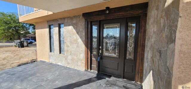 doorway to property featuring stucco siding