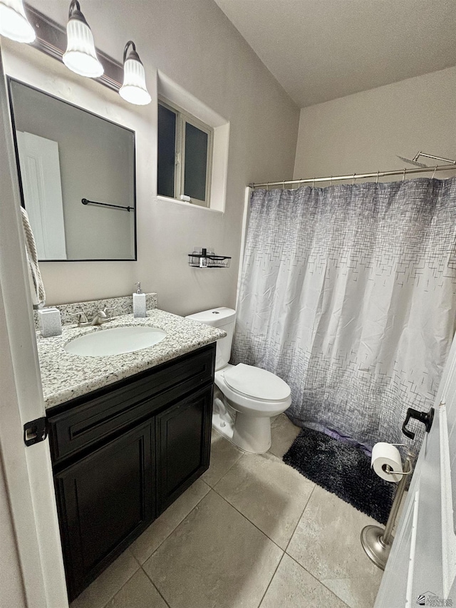 bathroom with tile patterned flooring, a shower with shower curtain, toilet, and vanity