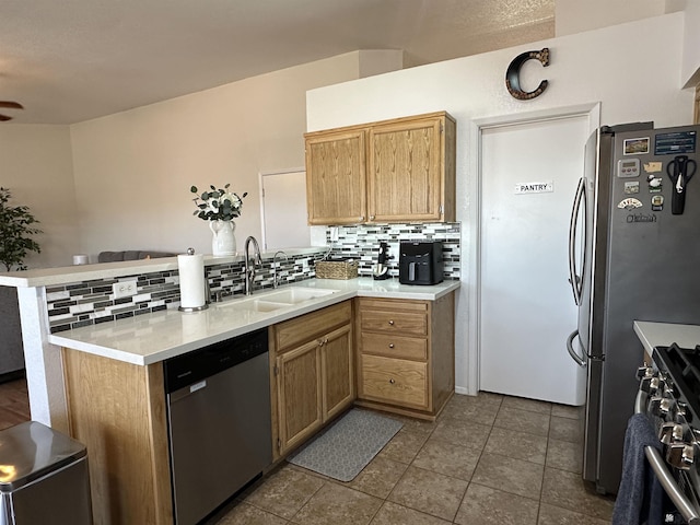 11228 E 25th St, Yuma, AZ 85367 - kitchen with stainless steel appliances, a peninsula, a sink, and decorative backsplash