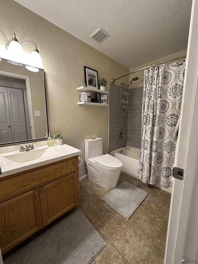 11228 E 25th St, Yuma, AZ 85367 - bathroom featuring a textured wall, a textured ceiling, toilet, vanity, and tile patterned floors