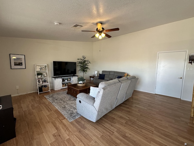 11228 E 25th St, Yuma, AZ 85367 - living area with ceiling fan, wood finished floors, a textured ceiling, and baseboards